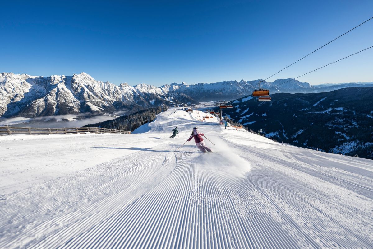 Skifahren auf sonnigen Pisten mit weitem Bergpanorama in Leogang